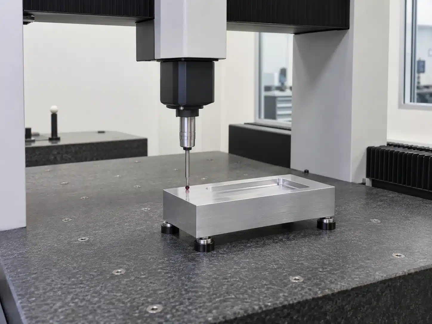 CMM probe inspecting a precision CNC machined part